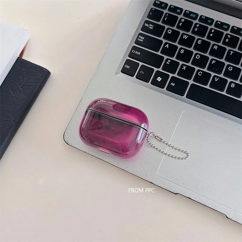 Pink transparent case with a chain on a laptop